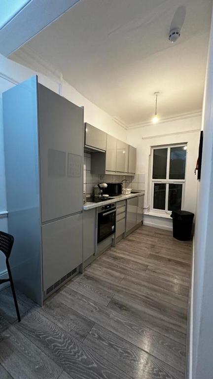 a kitchen with stainless steel appliances in a room at Wandsworth Guest Studio 64 in London