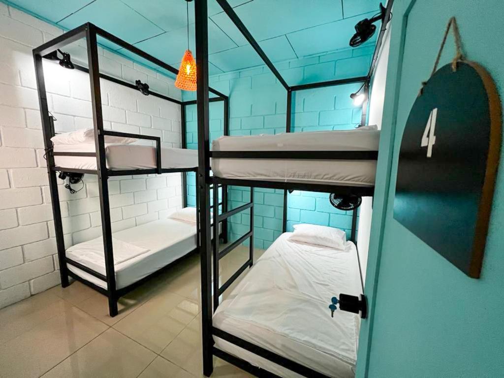 - une chambre avec 3 lits superposés dans un bâtiment dans l'établissement Lolas Hostal, Habitacion Exclusiva para Mujeres, 2 camarotes, precio por cama, à San José