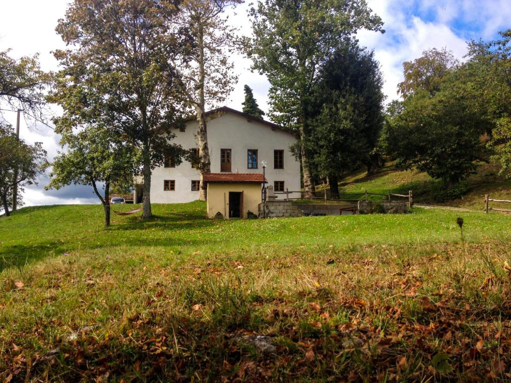 ein weißes Haus auf einem Grasfeld in der Unterkunft Il Borrino in Gavinana