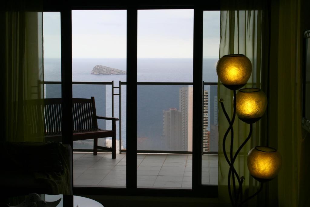 a room with a window with a view of the ocean at Benidorm Skyline in Benidorm