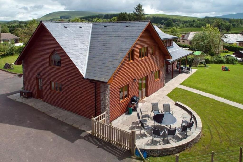 an aerial view of a barn with a table and chairs at Beech Tree Eco Lodge in Brecon