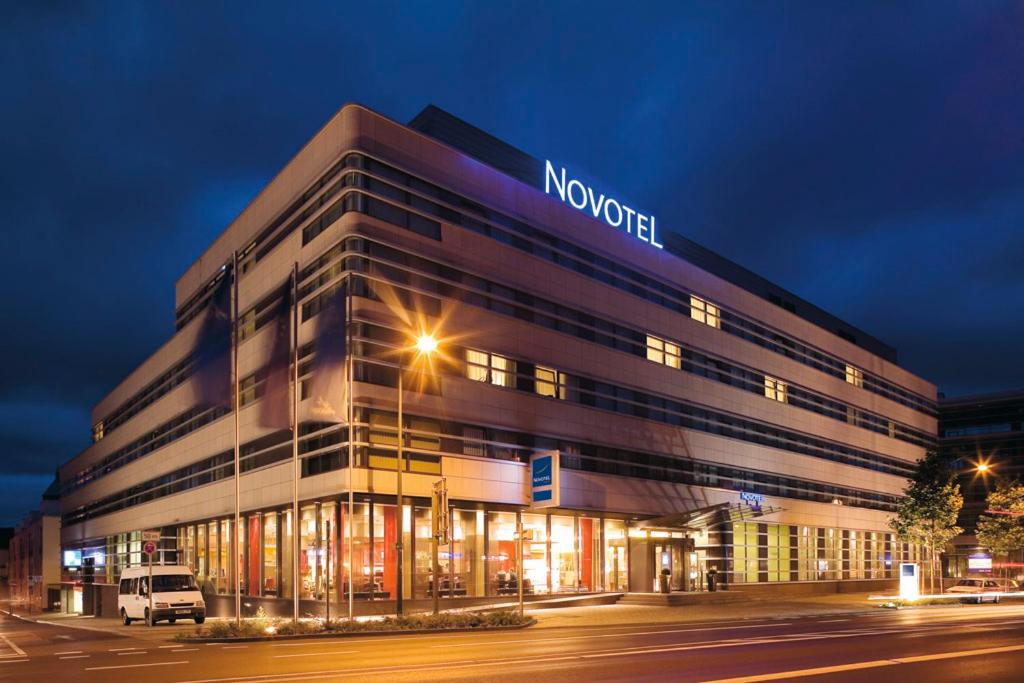 a building with a sign on the side of it at Novotel Aachen City in Aachen