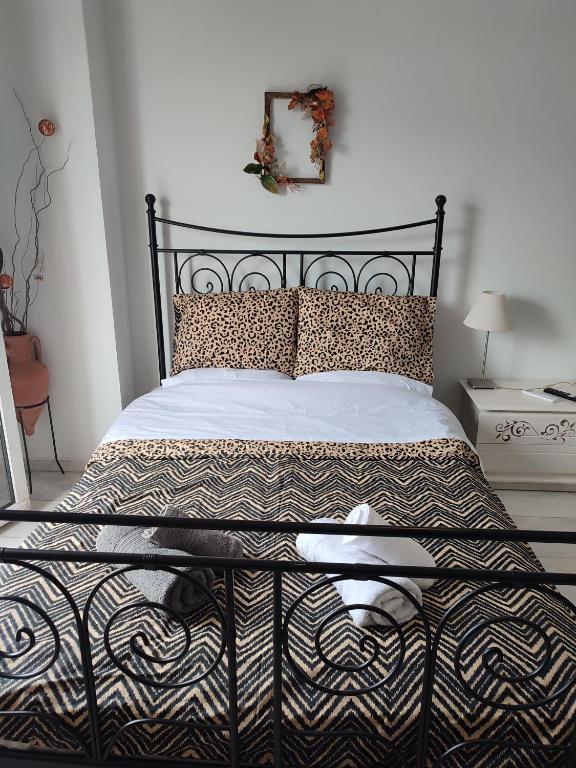 a bedroom with a bed with a black headboard at Ανατολή in Veria