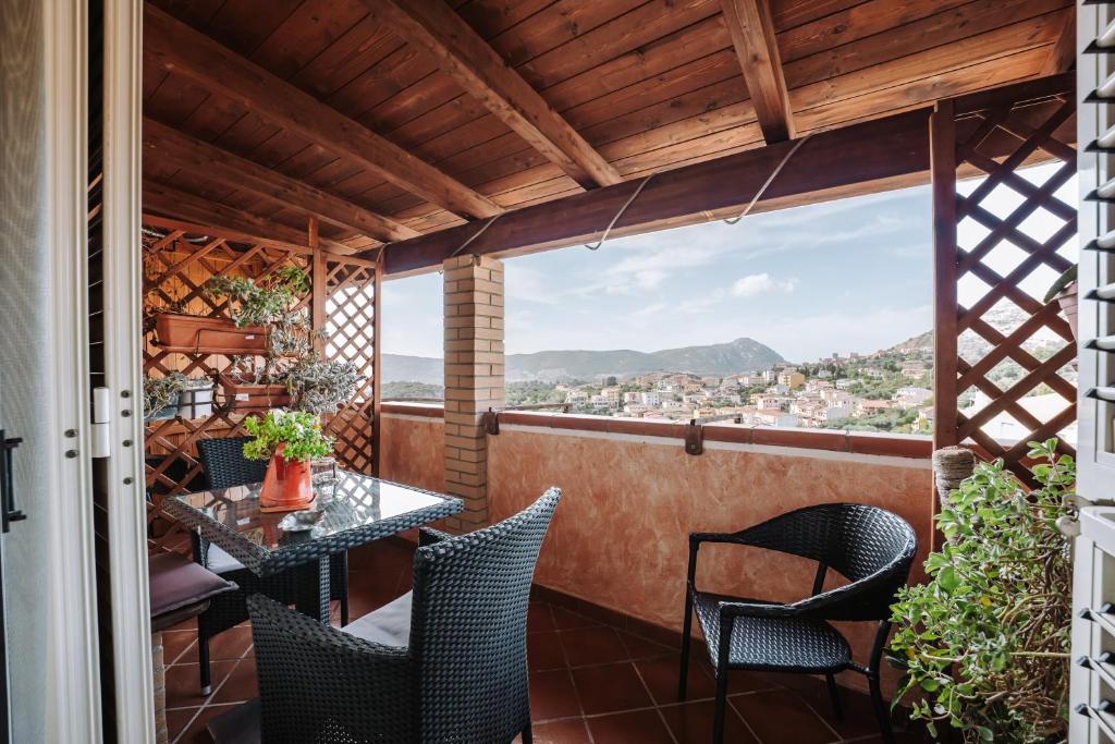 a balcony with a table and chairs and a view at Casa Francy in Iglesias