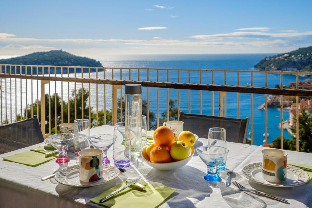 - une table avec un bol de fruits sur le balcon dans l'établissement Résidence le Clos Charmerade, à Villefranche-sur-Mer