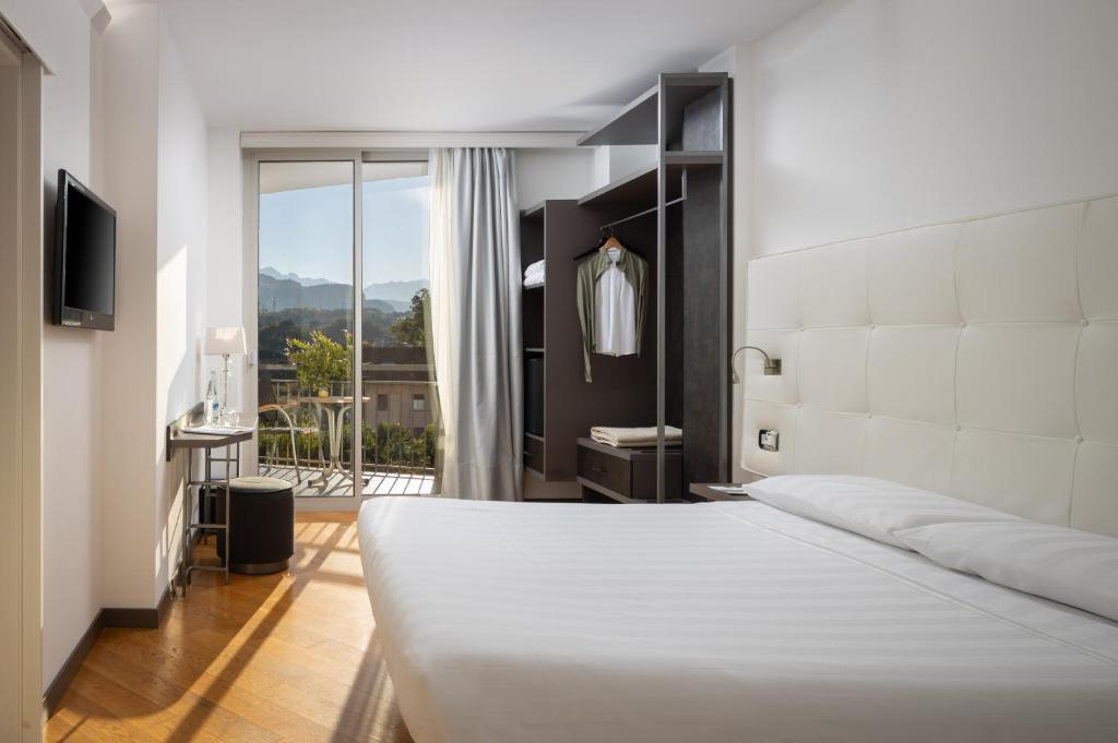 Postel nebo postele na pokoji v ubytování Hotel Continental - Tonelli Hotels