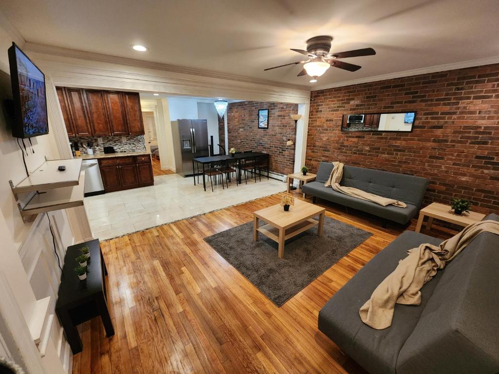 a living room with a couch and a table at Stylish 3 bed, minutes to NYC! in Jersey City