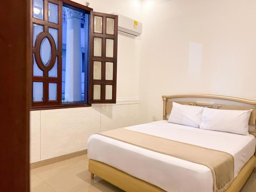 Giường trong phòng chung tại Hotel Barranquilla Prado