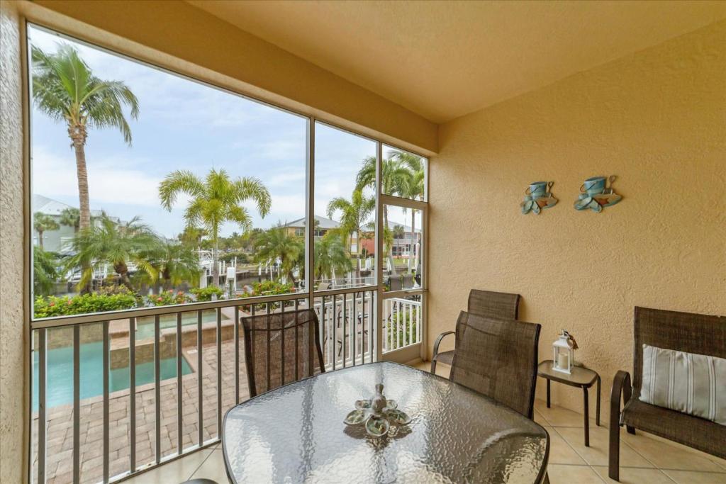 a balcony with a table and chairs and a view of the ocean at 3329 Purple Martin 112 in Punta Gorda
