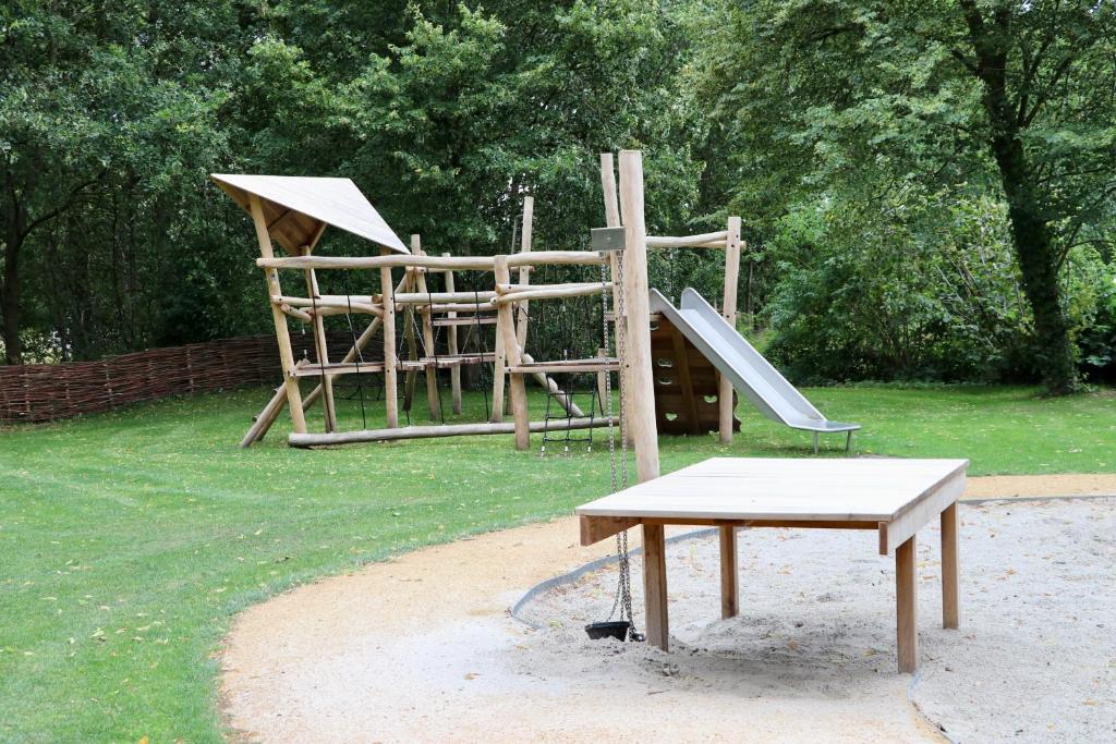 a park with a playground with a slide at Camping de Zwammenberg in De Moer