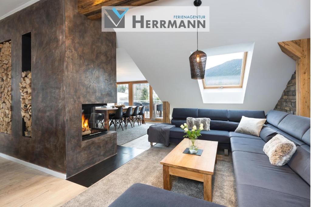 a living room with a blue couch and a fireplace at Chalet am Breitenberg Appartement CB 12 in Pfronten
