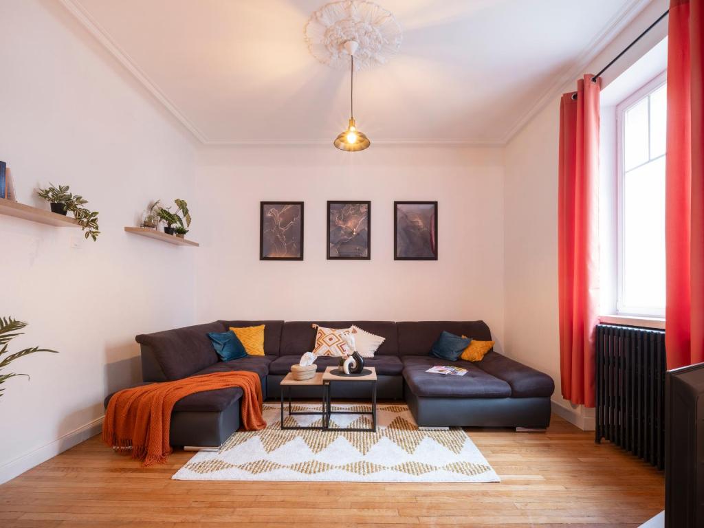 uma sala de estar com um sofá e uma mesa em Le Haut Cloquais - SereniStay em Metz