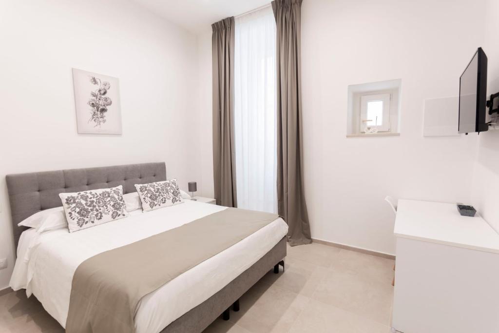 Postel nebo postele na pokoji v ubytování B&B Torre Canina suite & rooms