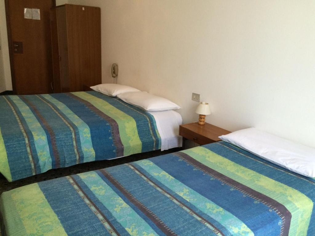 Postel nebo postele na pokoji v ubytování Hotel Aurora