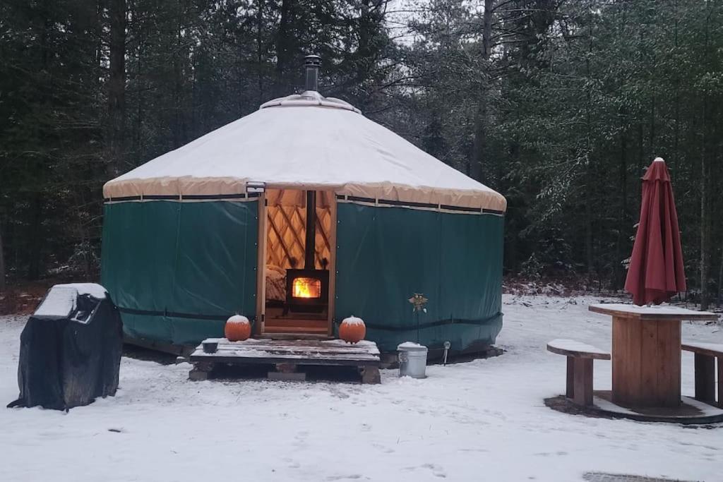 Una yurta con fuego en la nieve en Ava Jade Yurt, en Brownfield