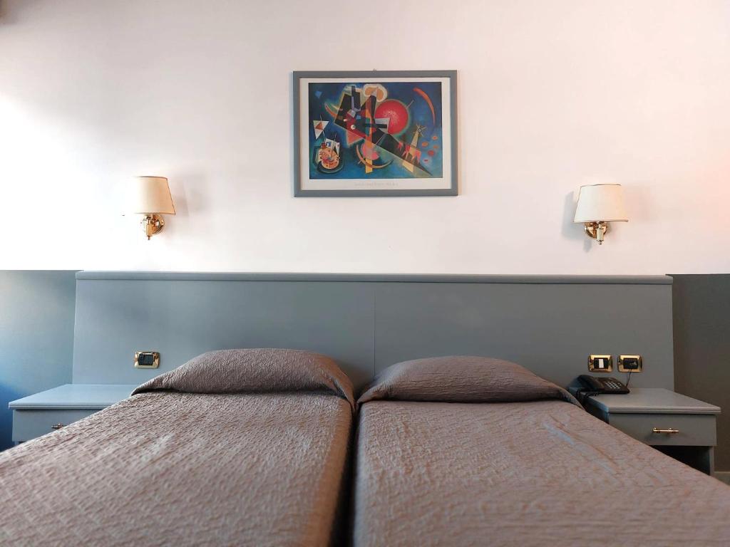 Ένα ή περισσότερα κρεβάτια σε δωμάτιο στο Hotel Vitruvio