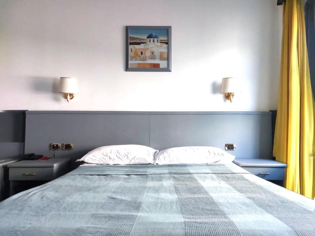 Ένα ή περισσότερα κρεβάτια σε δωμάτιο στο Hotel Vitruvio