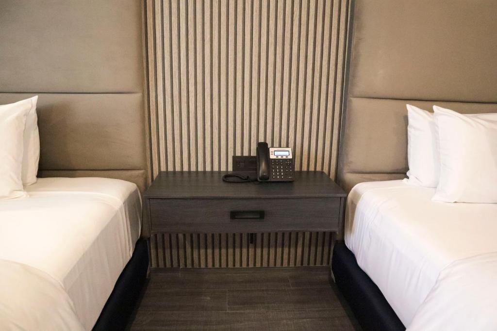 Postel nebo postele na pokoji v ubytování HUNICO HOTEL