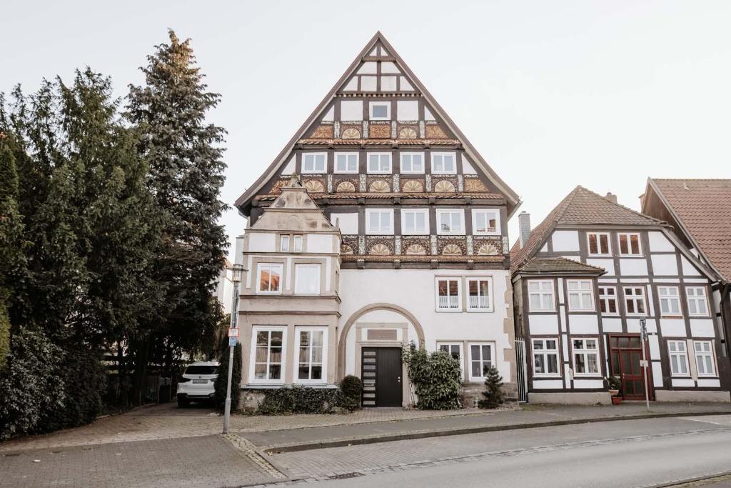 a large white building with a gambrel roof at Altstadt Apartment Lemgo in Lemgo