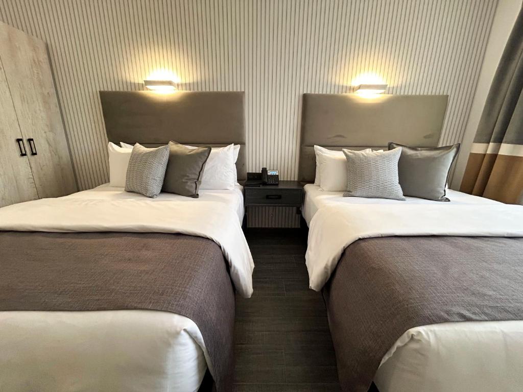 Postel nebo postele na pokoji v ubytování HUNICO HOTEL