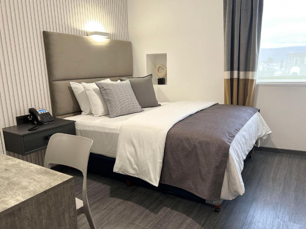 Postel nebo postele na pokoji v ubytování HUNICO HOTEL