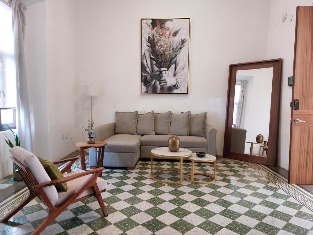 a living room with a couch and a table at Casa Monarcas - Sophia (with AC) in Guadalajara