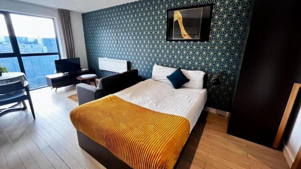 a hotel room with a bed and a chair at Modern Studio Apartment by BOLD Apartments in Liverpool