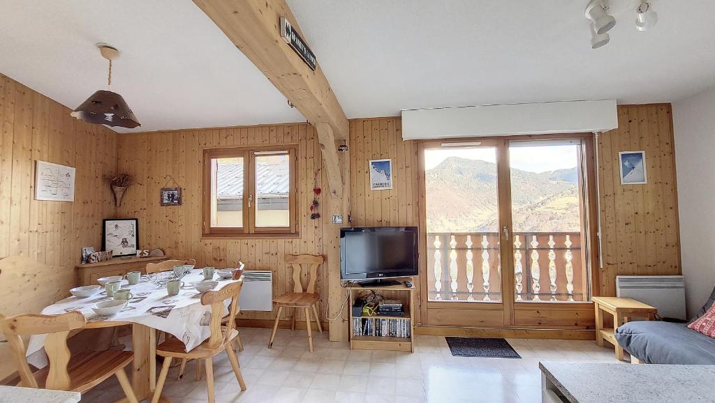 une salle à manger avec une table et une télévision dans l'établissement Grand Cerf 78, à Saint-Jean-dʼAulps
