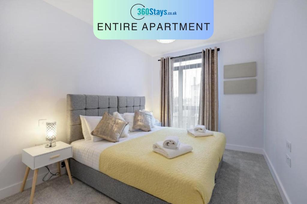 a bedroom with a bed with two towels on it at Belmore 1 & 2 Bedroom Luxury Apartments with Parking in Stanmore, North West By 360 Stays London in Stanmore