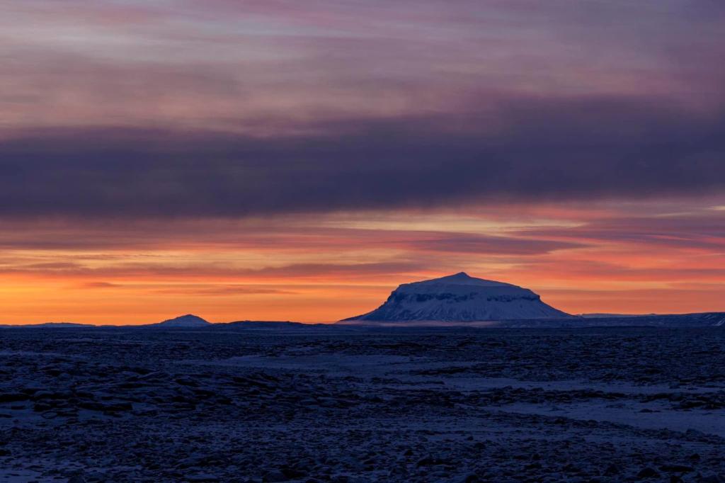 a mountain in the desert under a sunset at Holssel road 864 in Myvatn