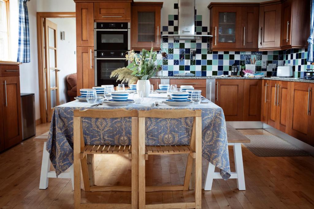 a kitchen with a table with blue and white dishes on it at Beautiful Cornish Home "High on the Cliffs" in Praa Sands