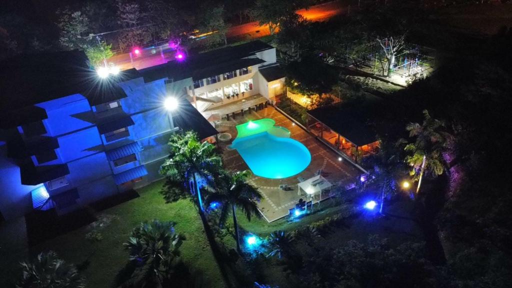 an overhead view of a house with a swimming pool at night at HOTEL EXBINT RESORT in Paz de Ariporo