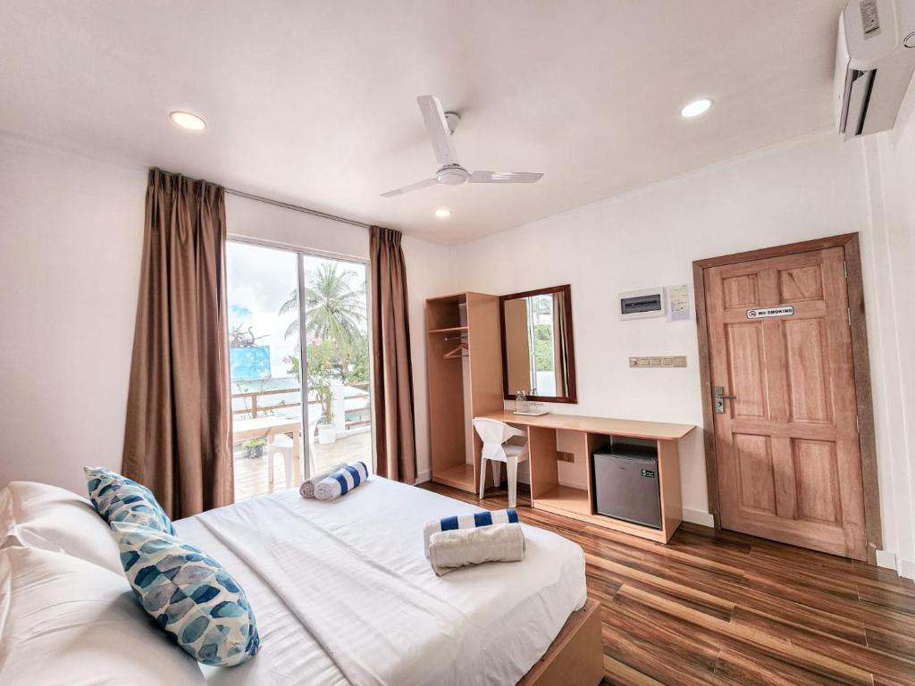 Postel nebo postele na pokoji v ubytování Raalhu Fonu Maldives