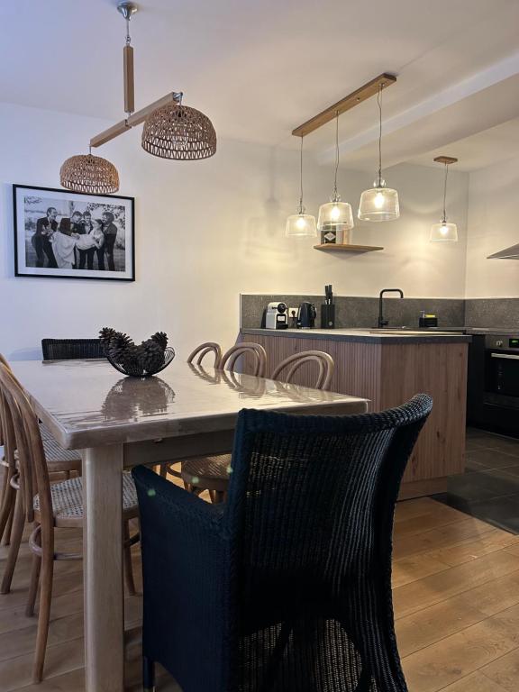 a kitchen and dining room with a table and chairs at Maison De Charme En Bourgogne in Saint-Gengoux-le-National