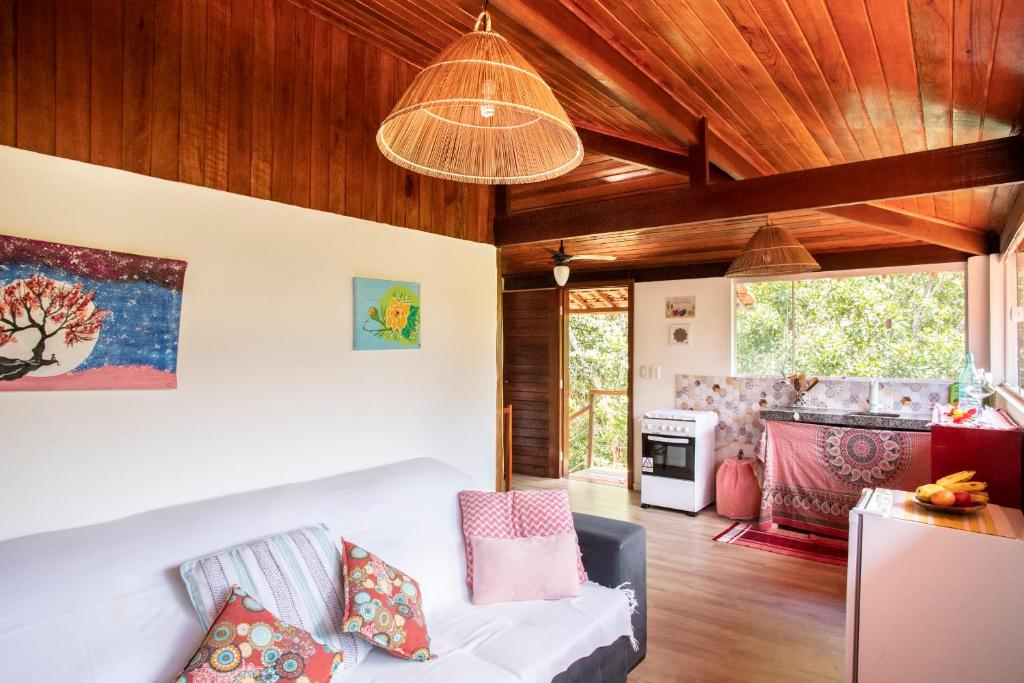 a living room with a white couch and wood ceilings at Pipa Surf Yoga in Pipa