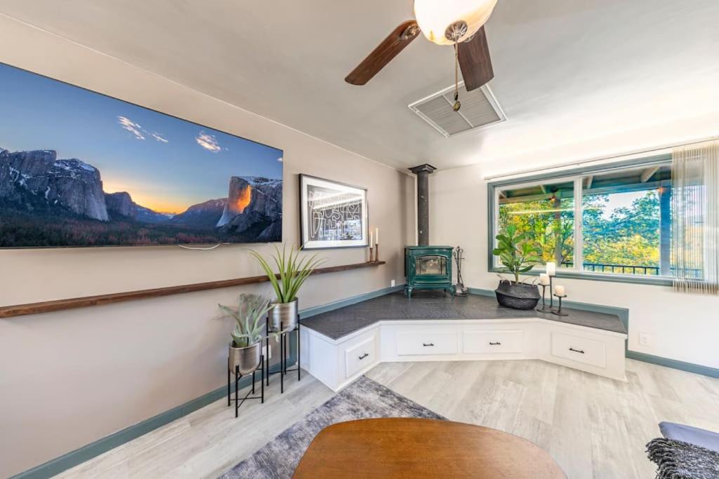 a living room with a large painting on the wall at Starry Night Cabin at Sky Ranch in Oakhurst