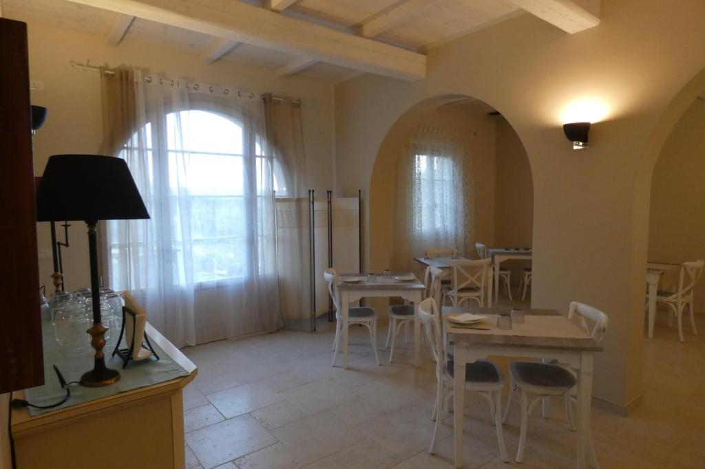a dining room with tables and chairs and a window at b&b Tenuta il Molino in Quercianella