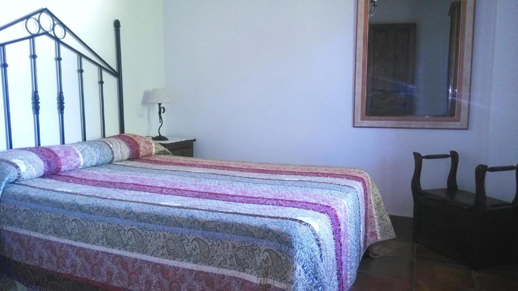 A bed or beds in a room at Apartamentos La Huertona