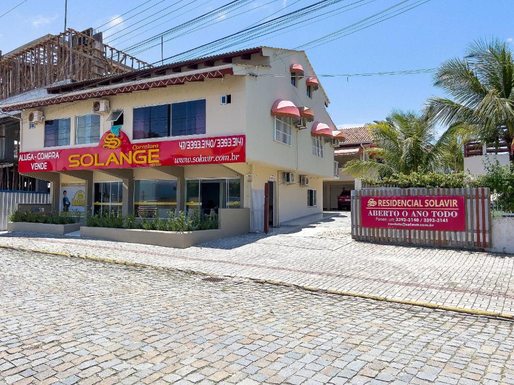 un edificio con señales rojas en el lateral de una calle en Ala Tainha - Residencial Solavir, en Bombinhas