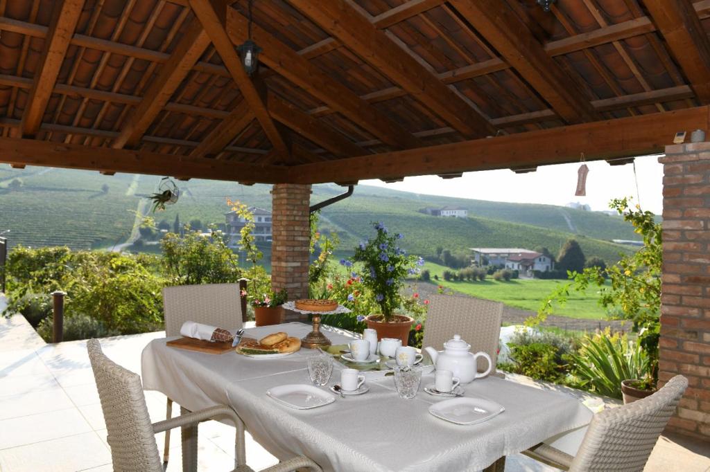 a white table with a tea set on a patio at Agriturismo EdMo in Castiglione Tinella