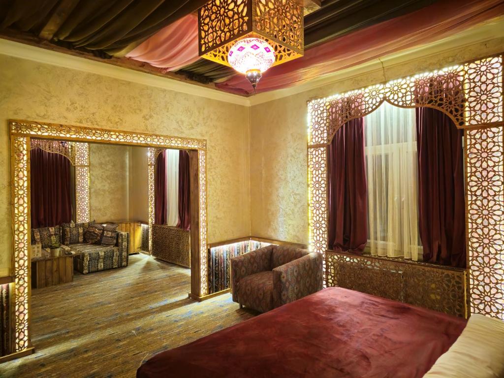 a living room with a mirror and a couch at Qiz Galasi Hotel Baku in Baku