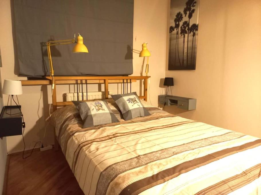 a bedroom with a large bed with two pillows at Metro Bemowo Comfort Apartment in Warsaw