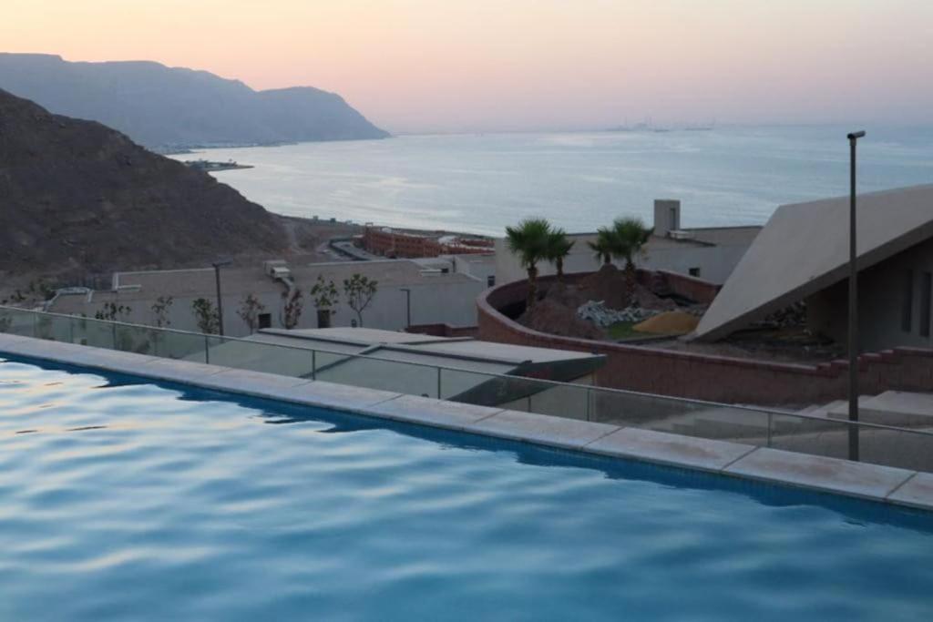 a swimming pool with a view of the ocean at IL Monte Galala Apartment - Families only 3 bed rooms in Ain Sokhna
