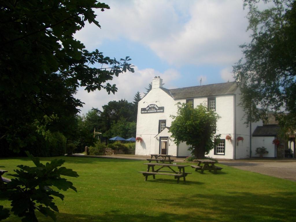 a white building with a picnic table in front of it at Royal Hotel in Dockray