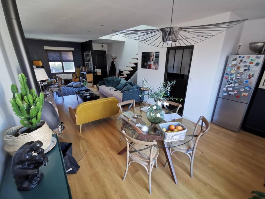 a living room with a table and a couch at Standing, calm &amp; confort. in Bègles