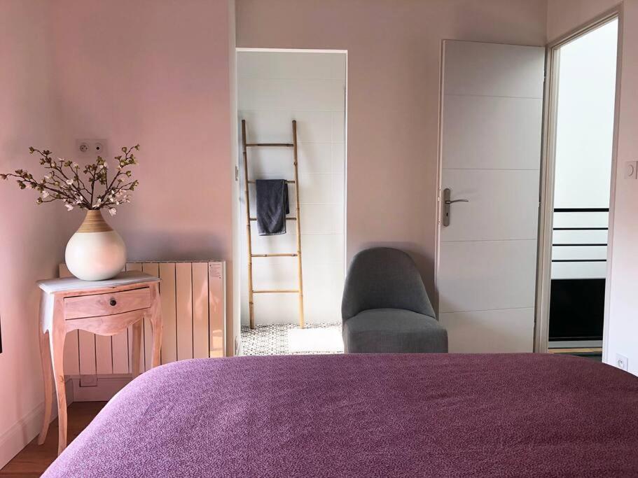 a bedroom with a purple bed and a chair at Standing, calm &amp; confort. in Bègles