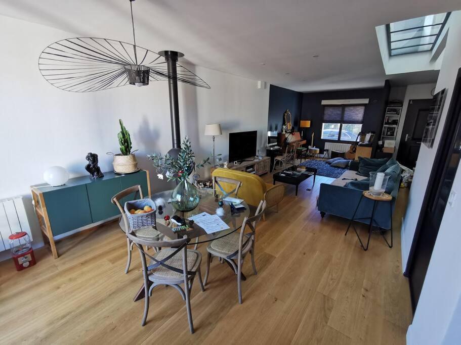 a living room with a table and chairs at Standing, calm &amp; confort. in Bègles