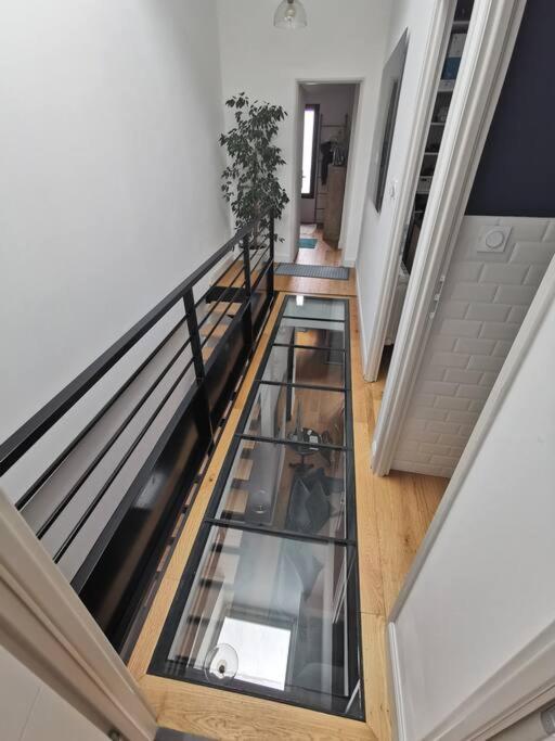 an empty hallway with a glass floor in a house at Standing, calm &amp; confort. in Bègles