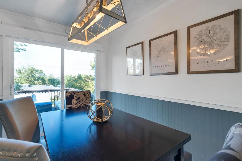 a dining room with a black table and a window at The Kentucky Bluegrass Retreat in Frankfort