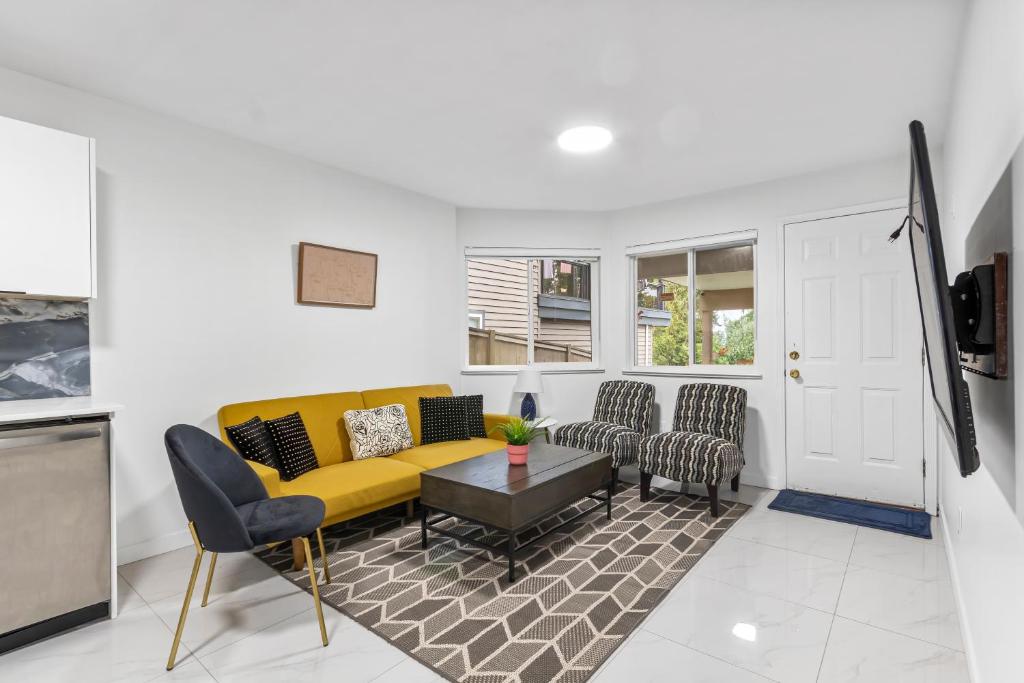 a living room with a yellow couch and chairs at Pristine 3 Beds 2 Washroom Guest Suite in Surrey